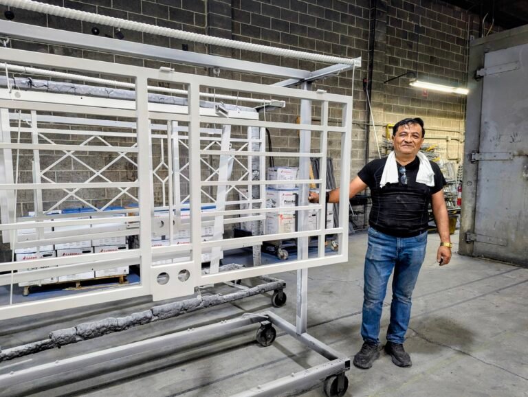 Local Portland powder coating specialist standing beside Mascotte steel security door frame prior to finishing